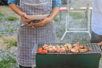Blurred images , A group of colleagues held a barbecue party. (BBQ) inside the villa after work to celebrate success. Barbecue (BBQ) Allows family members and friends to have activities together.
