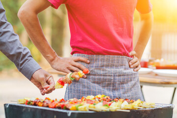 Blurred images , A group of colleagues held a barbecue party. (BBQ) inside the villa after work to celebrate success. Barbecue (BBQ) Allows family members and friends to have activities together.