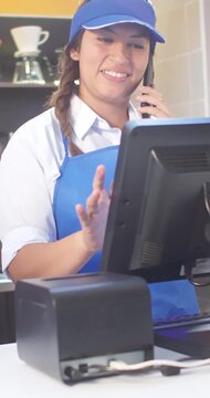 Portrait of a Latina girl working in a restaurant with home delivery service. Vertical shot for social media