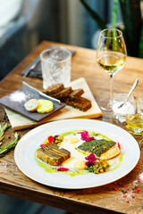 Pike-perch fillet. Potato gratin, warm yellow beet-turkey bean salad, parmesan dressing. Delicious seafood fish closeup served on a table for lunch in modern cuisine gourmet restaurant