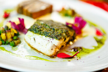 Pike-perch fillet. Potato gratin, warm yellow beet-turkey bean salad, parmesan dressing. Delicious seafood fish closeup served on a table for lunch in modern cuisine gourmet restaurant