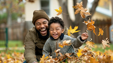 A joyful father and his son play with colorful autumn leaves in a park, sharing laughter and happiness.