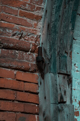 Old door hinges in the brick wall of the former stable