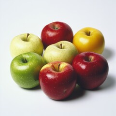 A medium shot of a variety of apples, including red, green, and yellow, isolated on a white background.