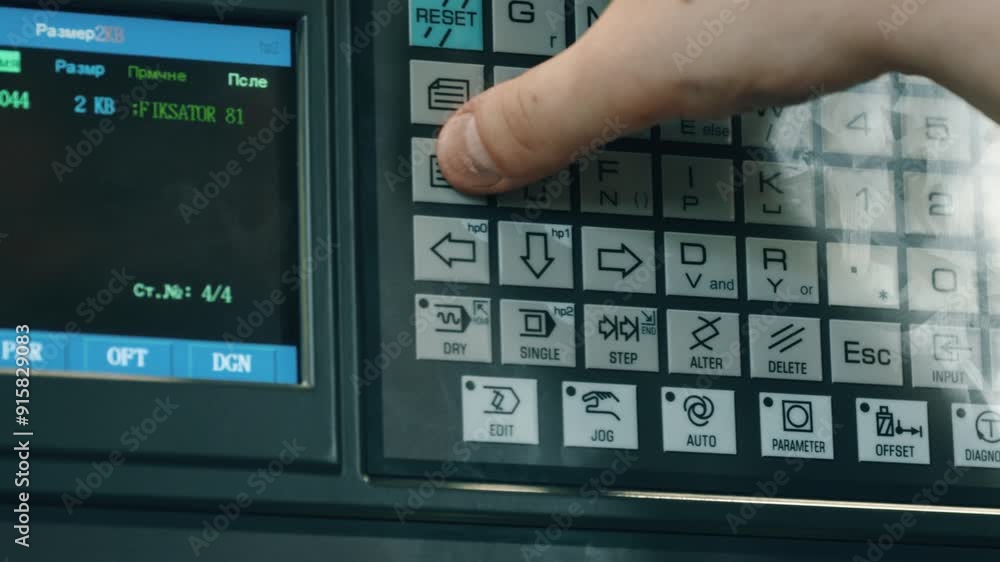 Poster close-up of a hand operating an industrial machine's control panel, pressing buttons and navigating 
