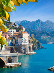 Picturesque view of Atrani on Amalfi Coast in province of Salerno, Campania region, Italy. Amalfi coast is popular travel and holyday destination in Italy. Ripe yellow lemons in foreground © IgorZh
