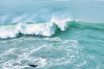 Wave splashing close-up. Crystal clear sea water, in the ocean in San Francisco Bay, blue water, pastel colors.