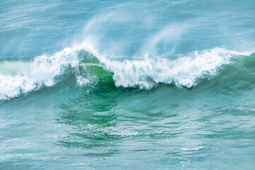 Wave splashing close-up. Crystal clear sea water, in the ocean in San Francisco Bay, blue water, pastel colors.