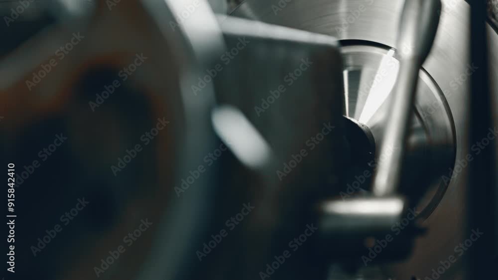 Poster close-up of a rotating metallic component in an industrial machine, showcasing shiny metal surface a