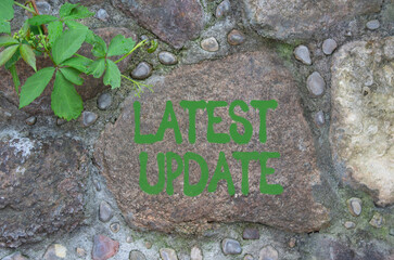 Latest update symbol. Stone wall with words Latest update. Beautiful stone background. Business and Latest update concept. Copy space.