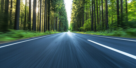 Obraz premium A truck speeding down a long, straight road through a dense forest, with tall trees lining both sides of the road