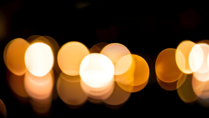 burning candle on black background