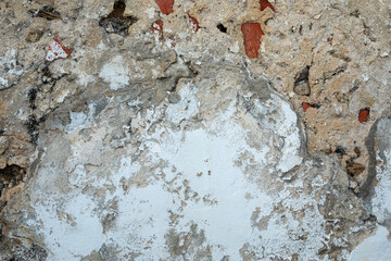 Timeworn wall with peeling paint revealing a glimpse of its history