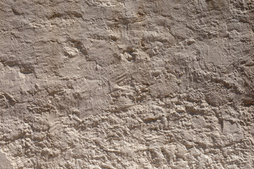 A textured wall with a rough weathered surface