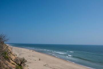 people enjoying the cape cod Massachusetts beach water during the height of summer