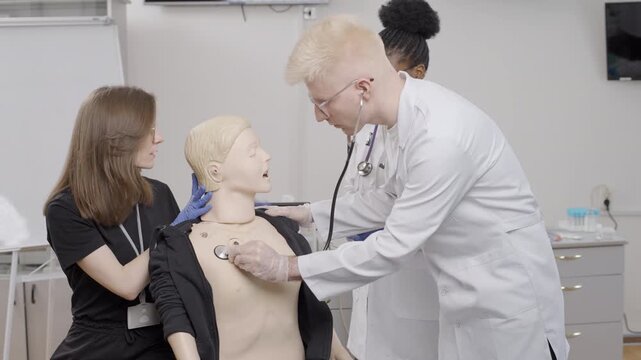 First aid training session in the clinic with a medical mannequin demonstration