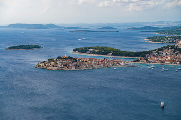 Fototapeta premium Amazing view on the small, tourist town of Primosten, Croatia built on the hill, surrounded by the sea and islands