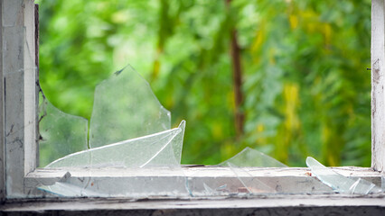 Smashed glass Window with old wooden frame. old window. finely broken glass. old house, retro....