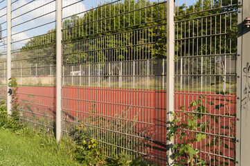 fenced basketball court outside in the sun