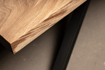 Expensive vintage furniture. The table is covered with epoxy resin and varnished. Luxury quality wood processing. Wooden table on a dark background. Black river made of epoxy resin.