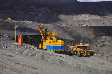 Heavy truck pours the road with water in the iron ore quarry. Dust removal, protection of the environment. Irrigation of the road from dust	