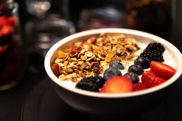 Healthy granola bowl with blueberries and strawberries.Healthy lifestyle.Healthy fruits.Kitchen in background