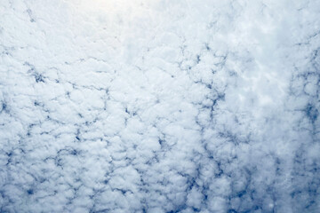 Blue sky background with tiny clouds. Nature background. Sky texture.