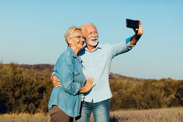 woman man outdoor senior couple happy lifestyle retirement together smiling love selfie camera mature