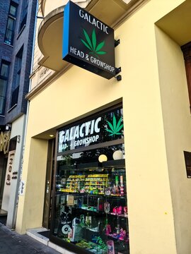 Cologne, Germany - 08 August 2024: The exterior view of the shop window of a Galactic Headshop brand cannabis store.