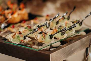 Assortment of delicious snacks on the open buffet festive table in restaurant. Catering plate