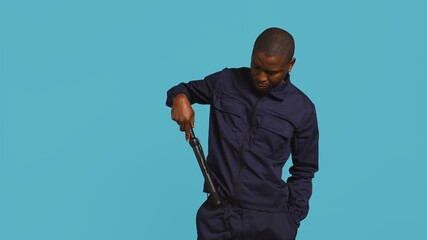 Portrait of security staff member tasked with evicting trespassers, intimidating them with baton....