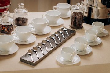 Group of empty white ceramic cups for coffee or tea in outside buffet at the business meeting event 