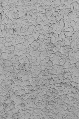 Peeling gray paint on the wall. Old cracked texture background