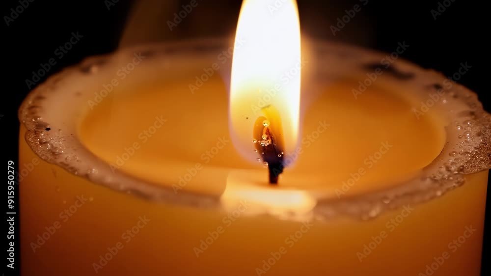 Poster A sequence of closeup shots capturing the gradual decrease in height of a burning candle as the wax melts and the flame gets closer to the base.