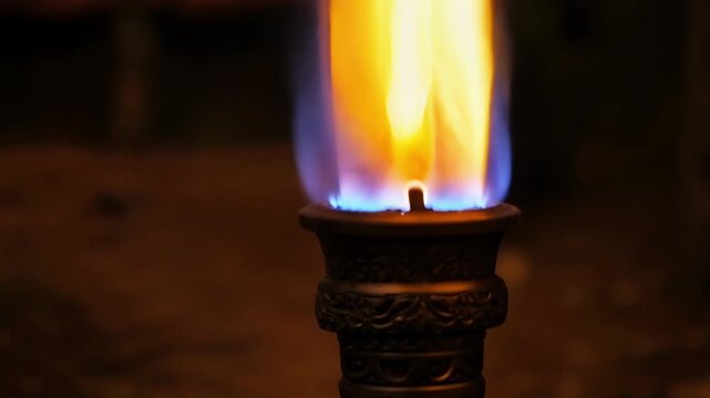 A tight shot of a torch showcasing the controlled and powerful flame as it burns steadily without faltering.
