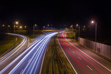 Long Exposure of a Highway Off-Ramp at Night in Brzesko with Car Lights Trail   Długi czar naświetlania -  zjazd z autostrady nocą w Brzesku ze smugami światła samochodów © Adrian White