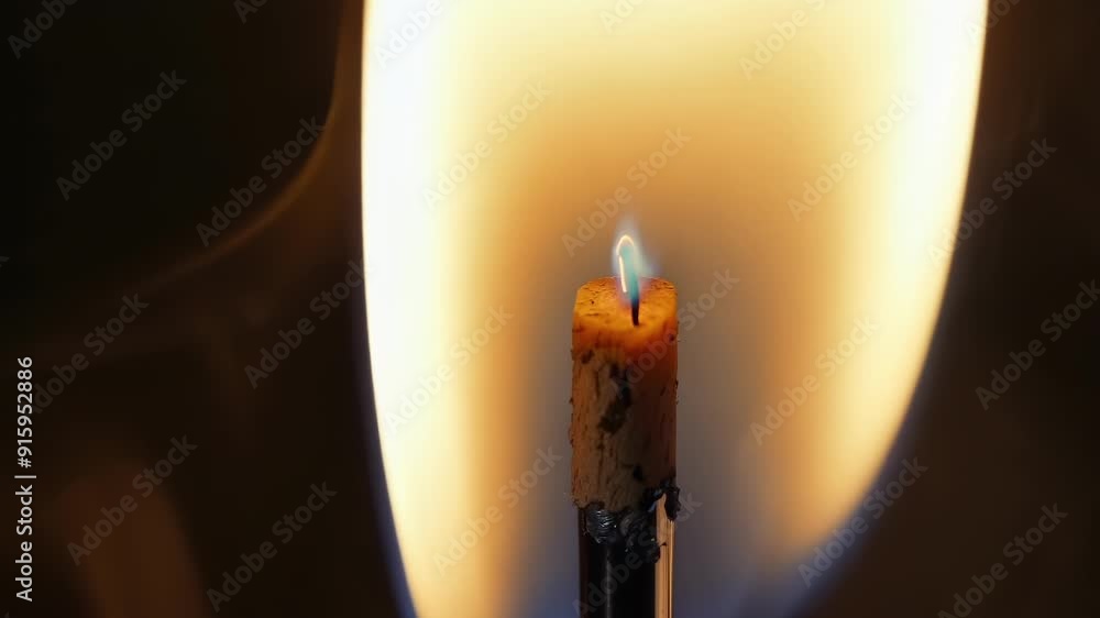 Aufkleber The flickering flame of a match casting flickers of light and trails of smoke creating a mesmerizing display.