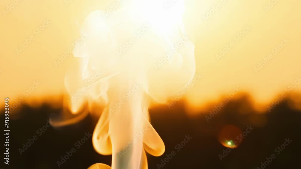 Poster a single strand of smoke slowly rises towards the sun highlighted by its golden rays.