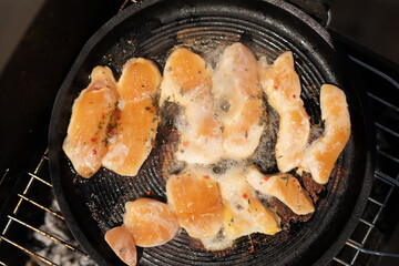 Chicken strips sizzling on the grill ready for a delicious meal