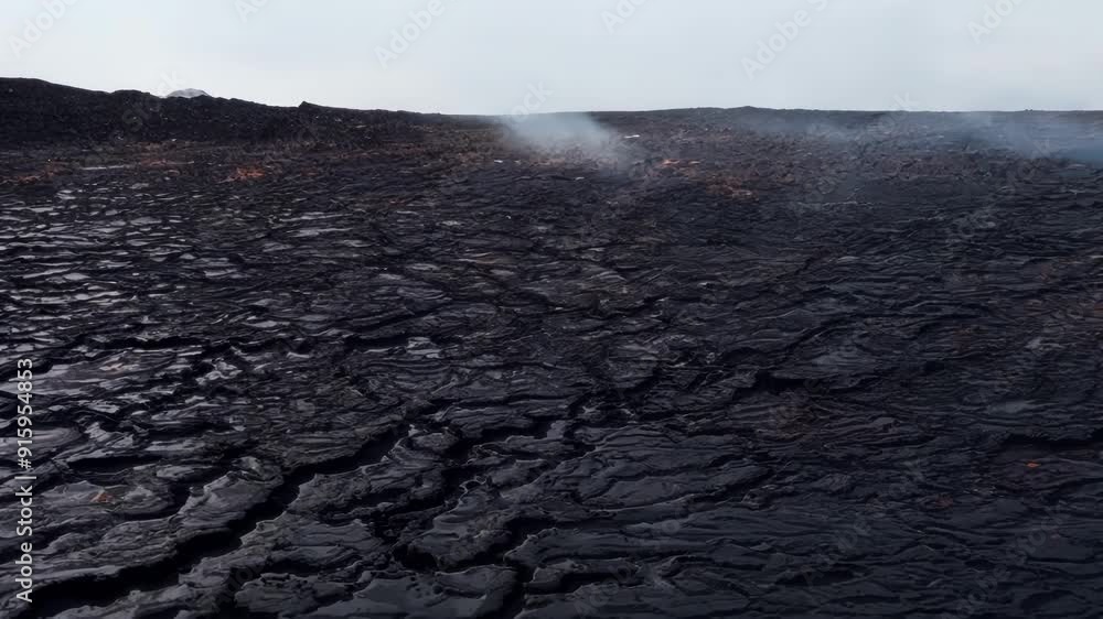 Poster As the lava cools thick layers of black jagged crust begin to form creating an otherworldly landscape of overlapping textures.
