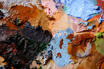Colorful abstract texture. Smears of oil paint and a palette knife on an art palette. The concept...