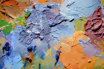 Colorful abstract texture. Smears of oil paint and a palette knife on an art palette. The concept...