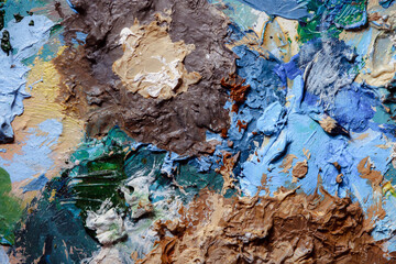 Colorful abstract texture. Smears of oil paint and a palette knife on an art palette. The concept...