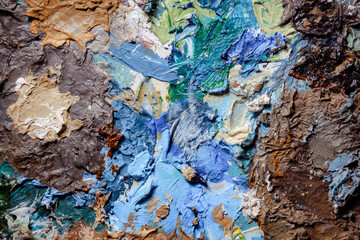 Colorful abstract texture. Smears of oil paint and a palette knife on an art palette. The concept of the modern school of art. Fragment of creative work. Colors of the year 2024