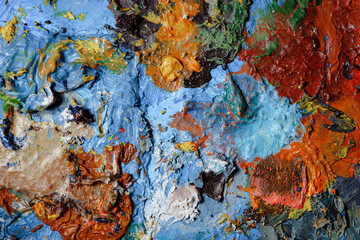 Colorful abstract texture. Smears of oil paint and a palette knife on an art palette. The concept...