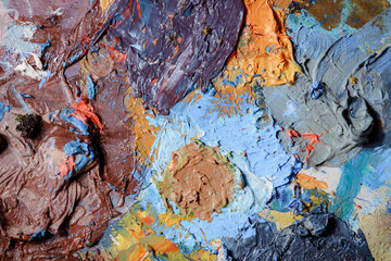 Colorful abstract texture. Smears of oil paint and a palette knife on an art palette. The concept...