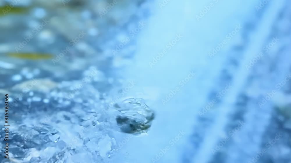 Poster extreme closeup of the waterfall spray capturing the tiny droplets as they fall and create ripples i