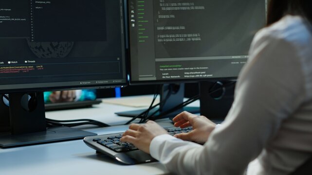 Computer scientist in data center installing software on computer, troubleshooting issues, handheld camera shot. Close up of IT expert in server hub establishing performance benchmarks, camera A