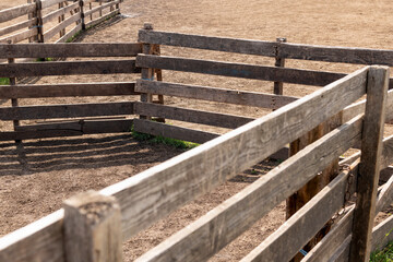 Close up of wooden fence enclosure at animal farm.