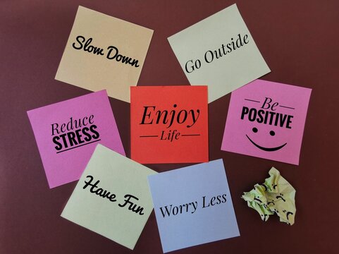 Colorful sticky notes with important life messages: reduce stress, worry less, go outside, slow down, have fun, be positive. A set of inspirational reminder notes. Healthy lifestyle motivation concept